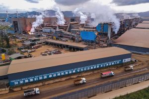 Aerial view of a large industrial plant with smoking chimneys