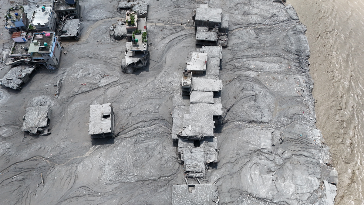 overhead view of grey mud engulfing buildings