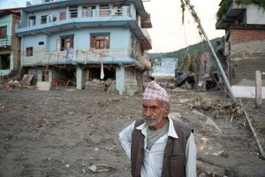 man outside on muddy street