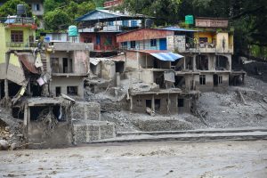 damaged concrete buildings near flooded road