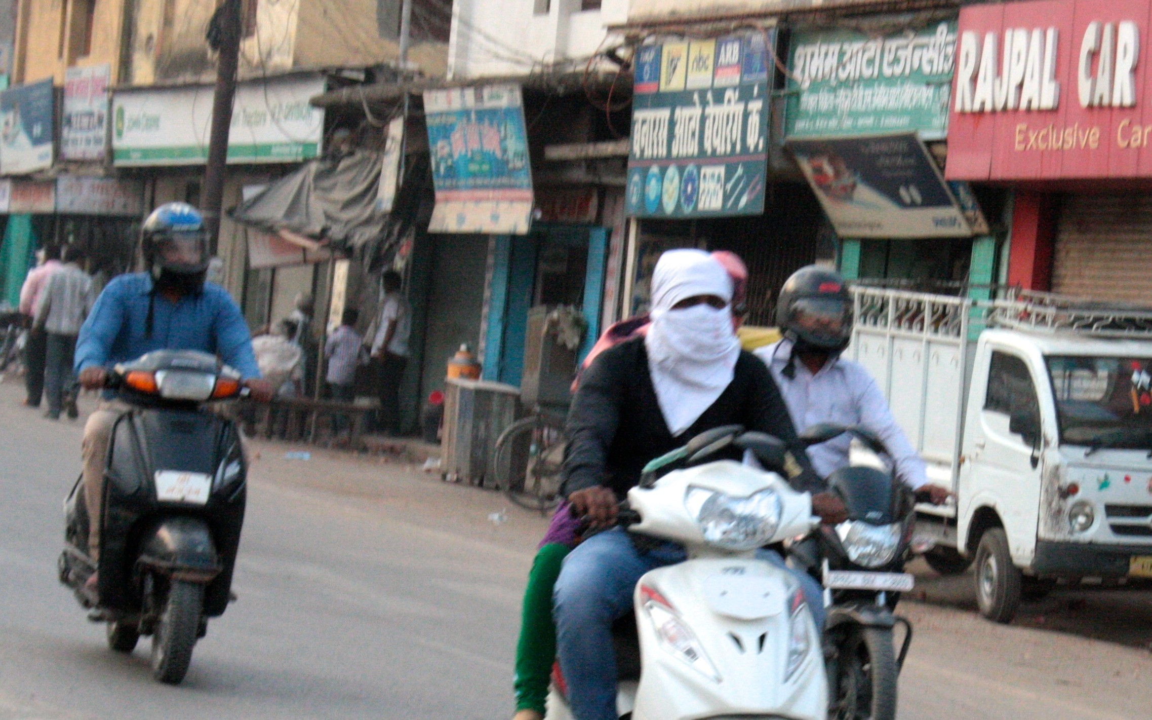 Woman covers her face protecting herself from vehicular traffic
