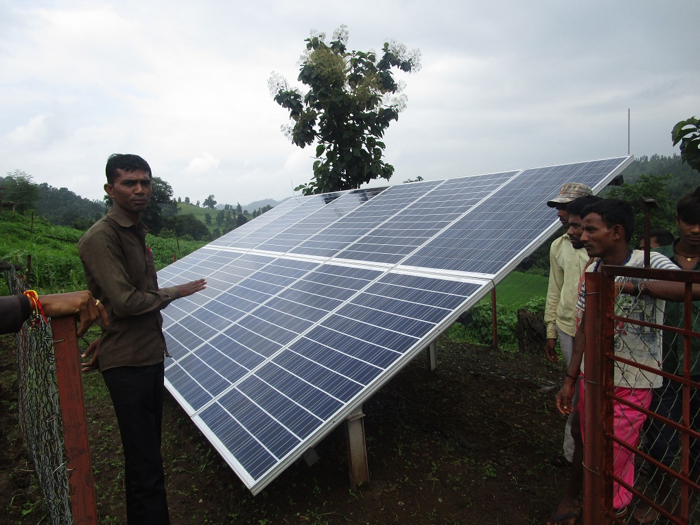 Residents of Bhojpada village explaining how the solar-powered water filtration system works [image by Nidhi Jamwal]