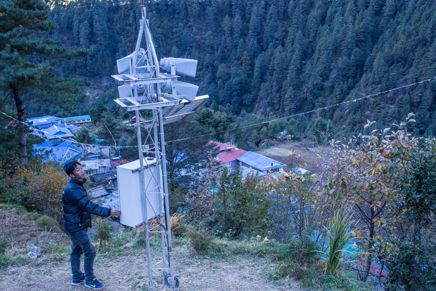 Nang Thume Sherpa, member of glacier lake taskforce shows the early warning system installed in Fakding village, Solukhumbu. The early warning system will send automated messages from from a sensor installed in Imja lake.