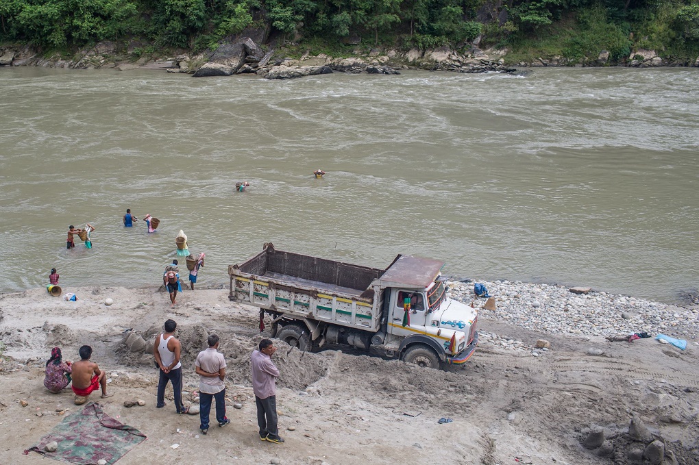 Legally banned in 1991, sand mining from riverbeds continues illegally in Nepal [image by Nabin Baral]
