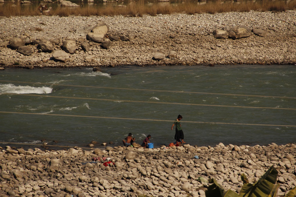 children wash their clothes in Trisuli river
